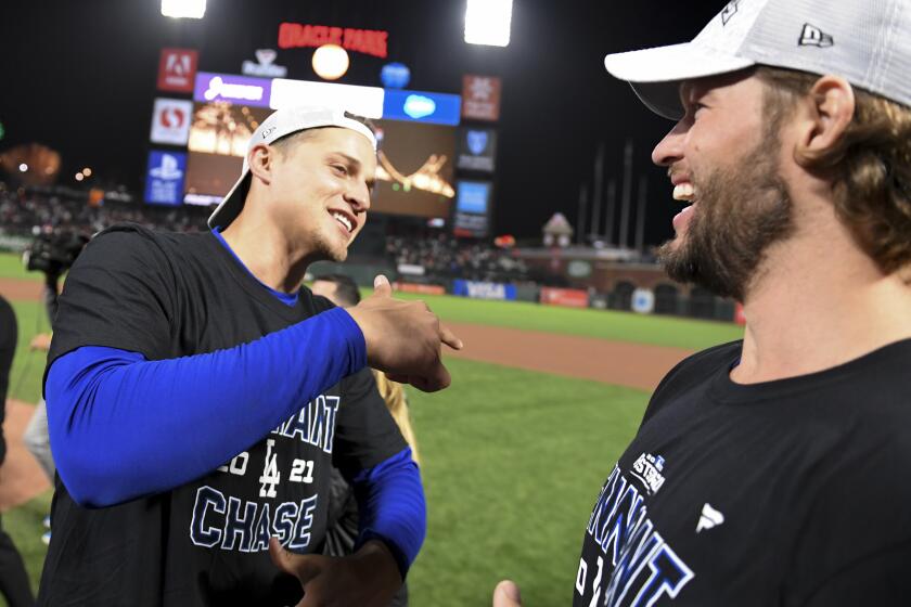 San Francisco, CA - October 14: Los Angeles Dodgers' Corey Seager, left, talks with Clayton Kershaw after game five of the 2021 National League Division Series against the San Francisco Giants at Oracle Park on Thursday, Oct. 14, 2021 in San Francisco, CA. The Dodgers won 2-1. (Wally Skalij / Los Angeles Times)