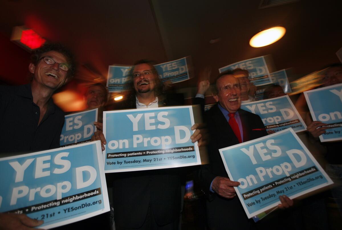 "Yes on D" campaign members celebrate after absentee vote count numbers put the measure ahead 64% as they gathered to watch returns at Lucky Strike Lanes on Hollywood Boulevard on election day.