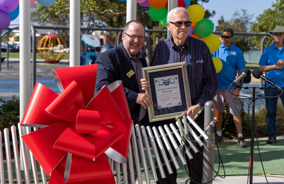 Mayor John Stephens and Richard Alexander Thursday outside the Donald Dungan Library in Costa Mesa.