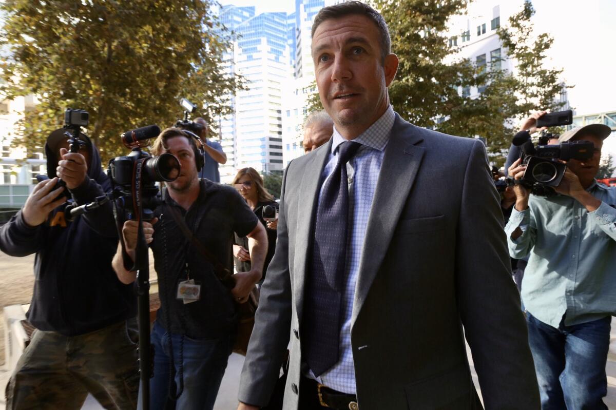 Rep. Duncan Hunter (R-Alpine) enters federal court in San Diego on Monday to request a postponement of his criminal trial.