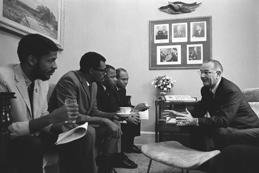 President Johnson, right, meets with John Lewis and others at the White House in 1965