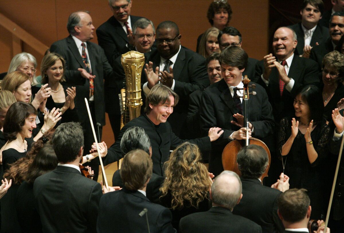 After his last concert as music director of the Los Angeles Philharmonic, Esa-Pekka Salonen is surrounded by his musicians on the stage of Walt Disney Concert Hall.