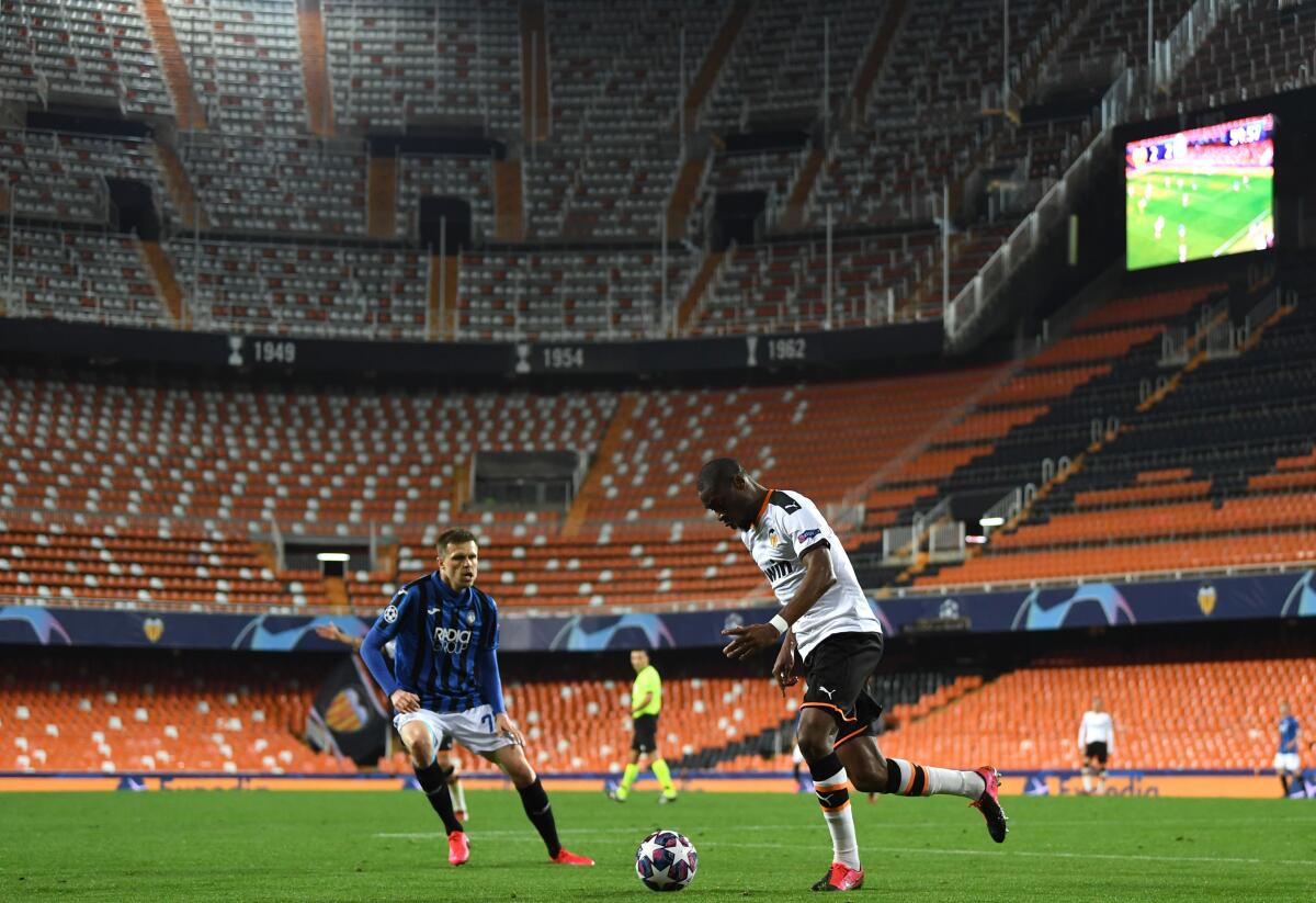 Atalanta's Josip Ilicic, left, and Valencia's Geoffrey Kondogbia in action during the UEFA Champions League round of 16 second leg match in Valencia, Spain on Tuesday.