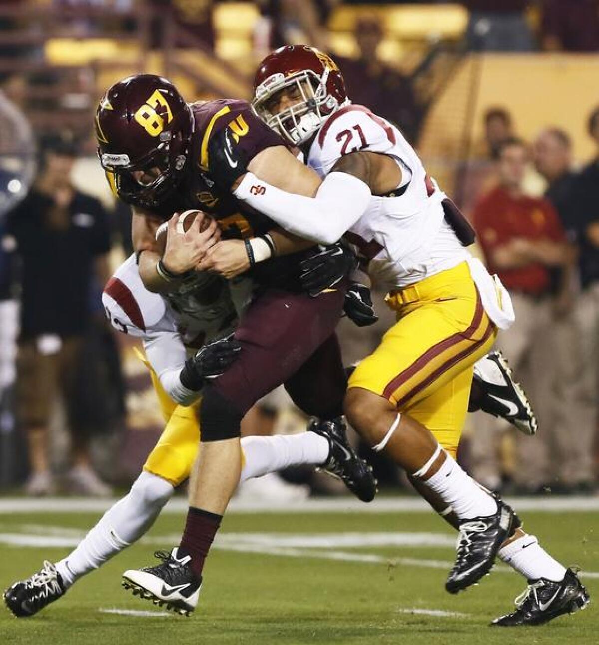 USC safety Su'a Cravens, right, tackles Arizona State tight end Chris Coyle during a game on Sept. 28. Don't expect to see Cravens contributing to the Trojans' offense in the near future.