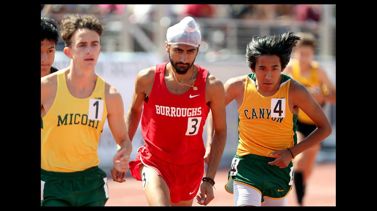Burroughs High School athlete Jagdeep Chahal finished third in the boys 3200 meter race, at the CIF SS Master's Track & Field Meet, at El Camino College in Torrance on Saturday, May 26, 2018. Xavier Court, left, from Mira Costa came in first and Canyon High School runner Ethan Danforth, right, came in second place.