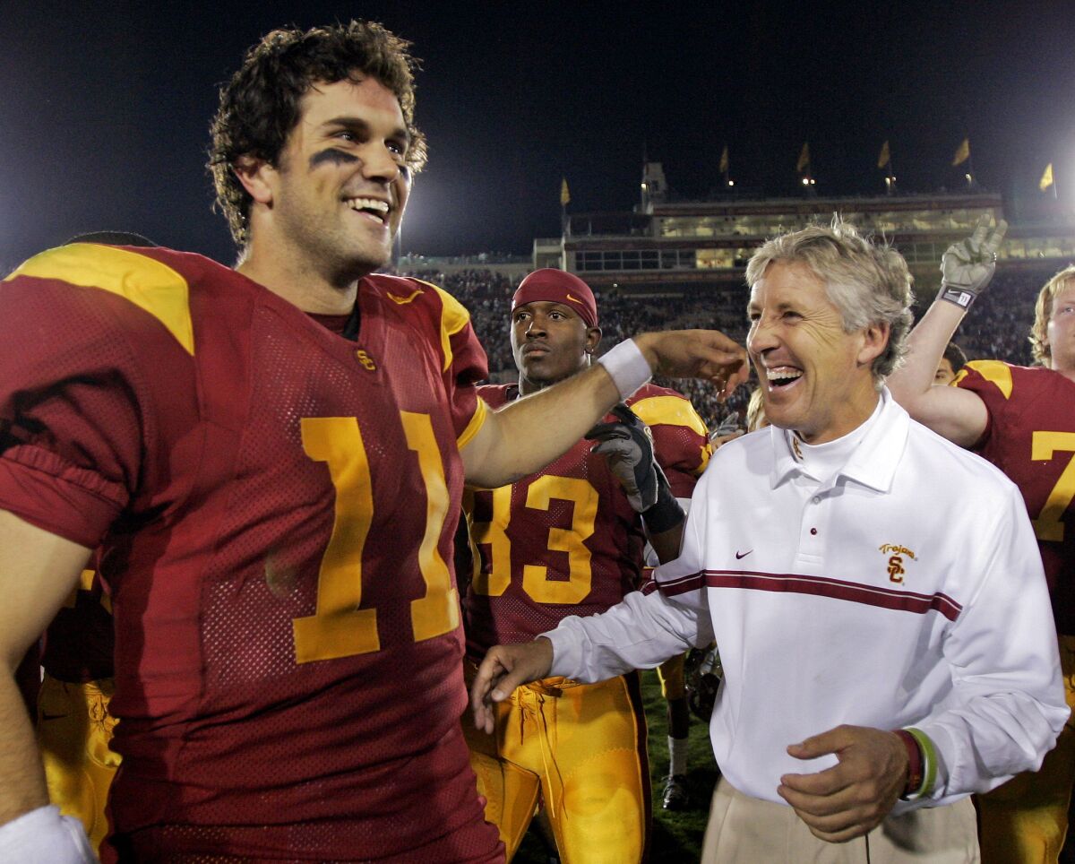 USC's Matt Leinart and coach Pete Carroll smile after a 2005 game