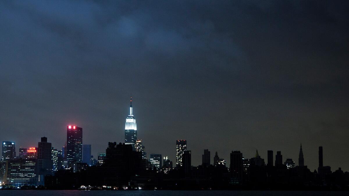 Much of the New York City skyline sits in darkness a day after Sandy, but the famed New York Marathon is still scheduled to take place Sunday.