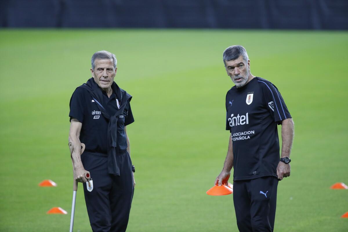 Uruguay's coach Oscar Tabarez (L) and his physical trainer Jose Herrera attend a training session of Uruguay's national team at the Netanya Stadium in the Israeli coastal city of Netanya on November 17, 2019, ahead of their friendly football match against Argentina. (Photo by Jack GUEZ / AFP) (Photo by JACK GUEZ/AFP via Getty Images) ** OUTS - ELSENT, FPG, CM - OUTS * NM, PH, VA if sourced by CT, LA or MoD **