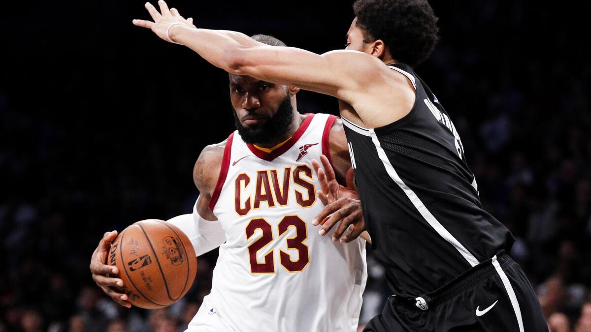 Cavaliers forward LeBron James tries to drive to the basket against Nets guard Spencer Dinwiddie during their game Wednesday night.