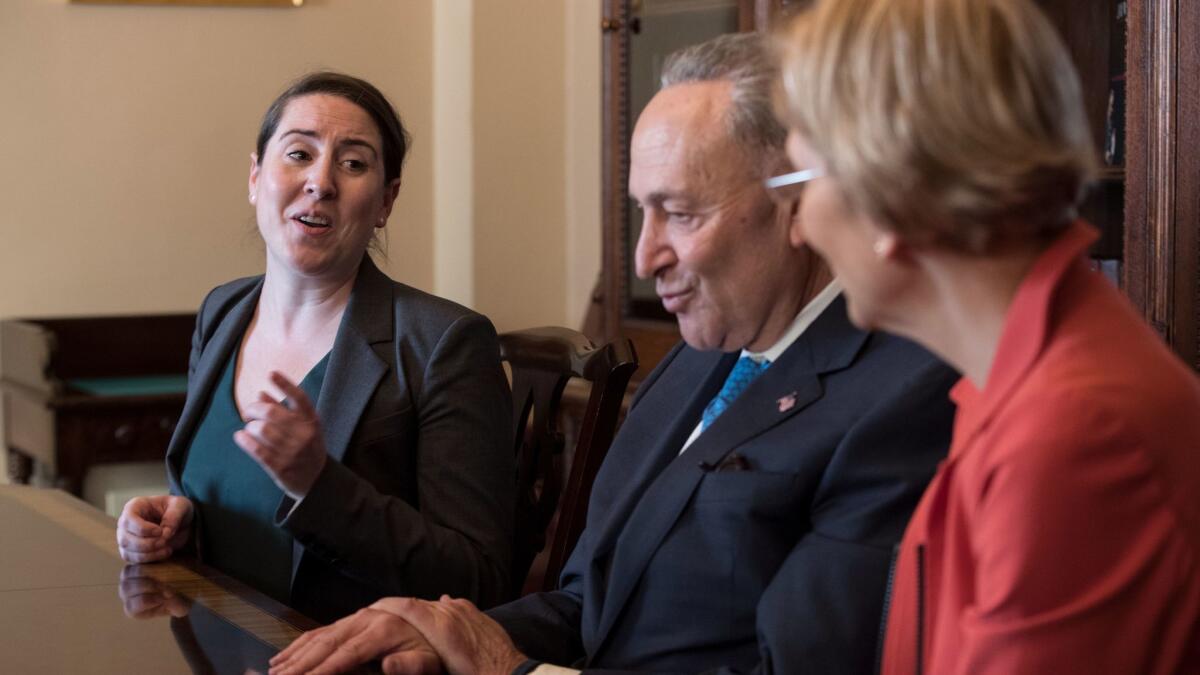 Leandra English, left, the deputy director of the Consumer Financial Protection Bureau, meets with Senate Minority Leader Chuck Schumer (D-N.Y) and Sen. Elizabeth Warren (D-Mass.) on Capitol Hill on Nov. 27.