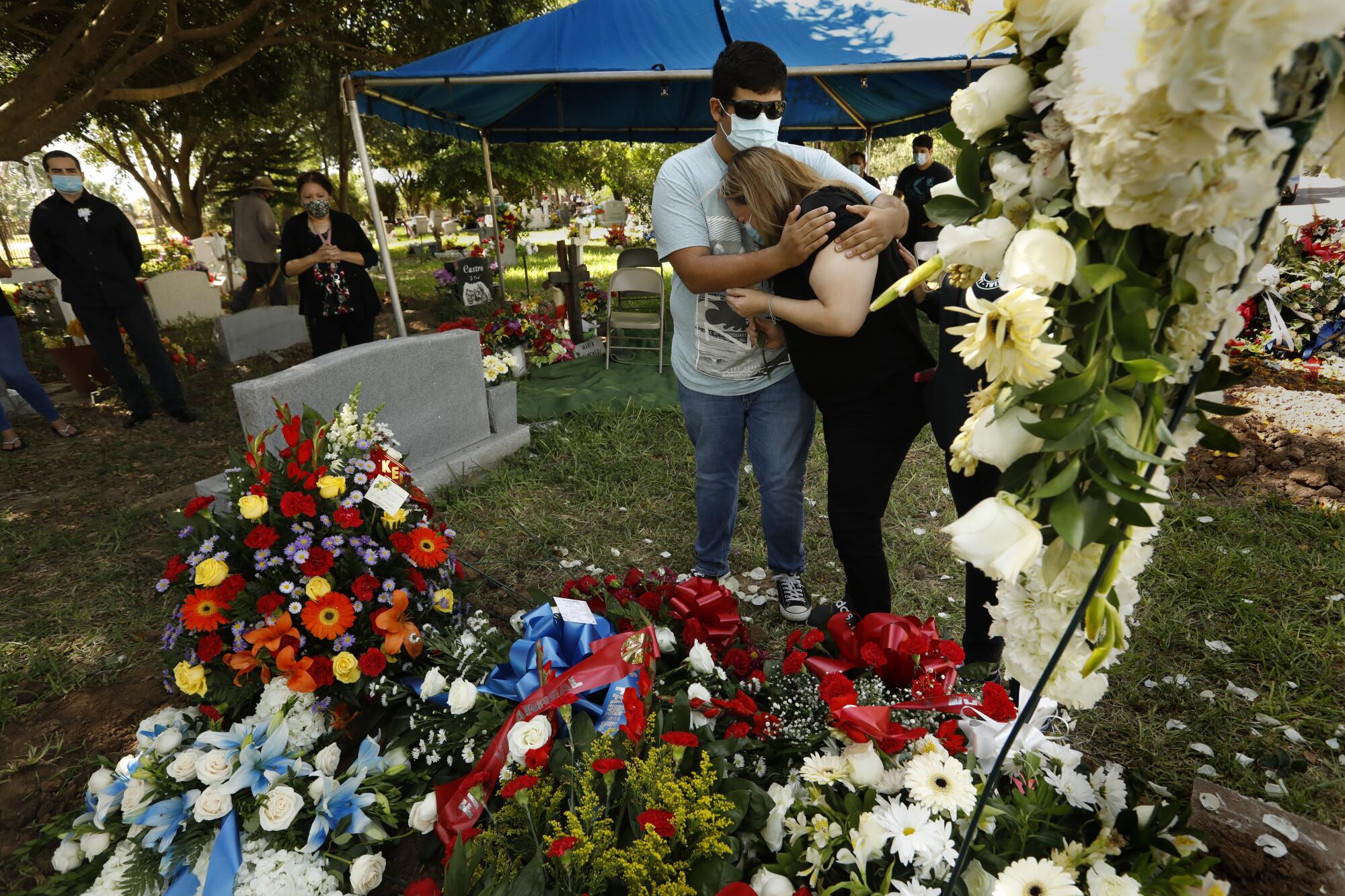 Family members mourn at the gravesite at La Piedad Cemetery in McAllen, Texas.