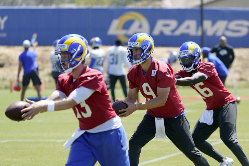Los Angeles Rams quarterbacks John Wolford, left, Matthew Stafford (9) and Bryce Perkins, right, participate in drills at the NFL football team's practice facility Monday, May 23, 2022, in Thousand Oaks, Calif. (AP Photo/Marcio Jose Sanchez)