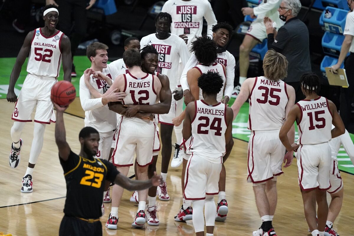 Oklahoma players celebrate their 72-68 victory over Missouri in the first round of the NCAA tournament on Saturday.