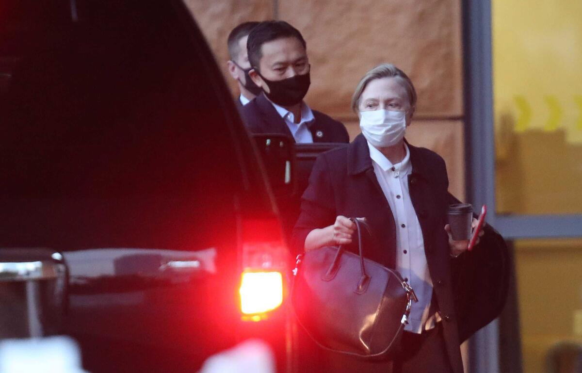 Former Secretary of State Hillary Clinton gets out of a car at UC Irvine Medical Center.