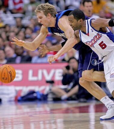 Clipper Cuttino Mobley, right, and Dallas Maverick Dirk Nowitzki battle for a loose ball during second quarter.
