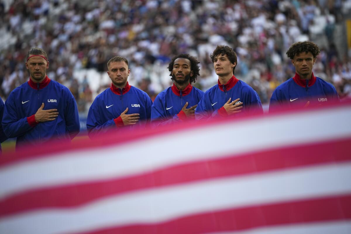 The U.S. men's soccer team sings the national anthem before the start of its match against New Zealand in Marseille, France.