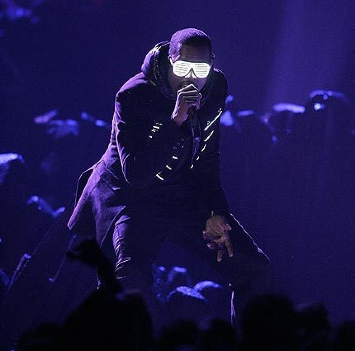 Kanye West performing with glow-in-the-dark shades on.