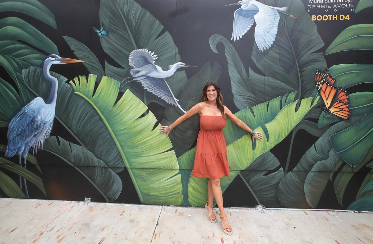 Debbie Avoux-Davis stands in front of her new mural, "Tropical Harmony," at Laguna Art-A-Fair on Thursday.