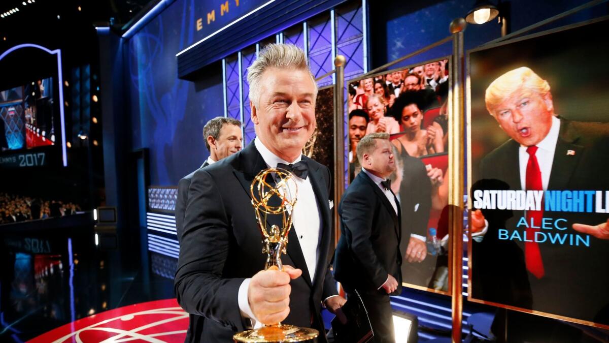 A happy Alec Baldwin shows off his Emmy for supporting actor in a comedy for his work on "Saturday Night Live," backstage at the Primetime Emmy Awards on Sunday.