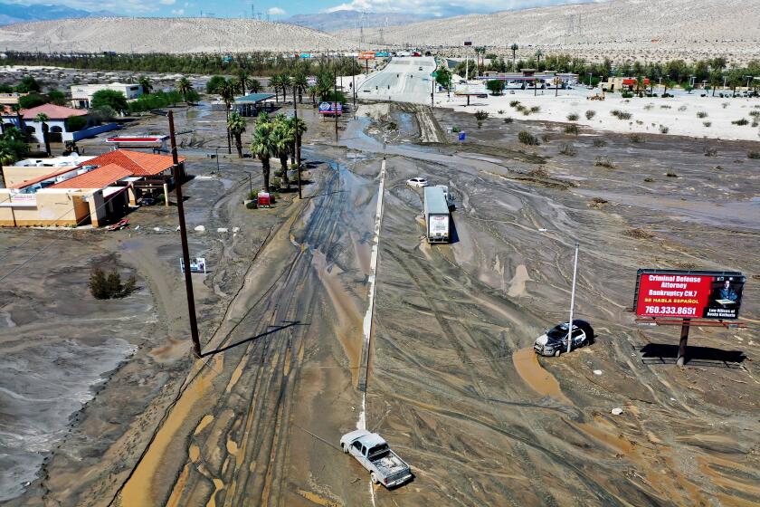 CATHEDRAL CITY, CALIFORNIA - AUGUST 21: An aerial view of stranded vehicles along a flooded street on August 21, 2023 in Cathedral City, California. Much of Southern California and parts of Arizona and Nevada are cleaning up after being impacted by Tropical Storm Hilary that brought several inches of rain that flooded roadways and winds that toppled trees and power lines across the region. (Photo by Mario Tama/Getty Images)