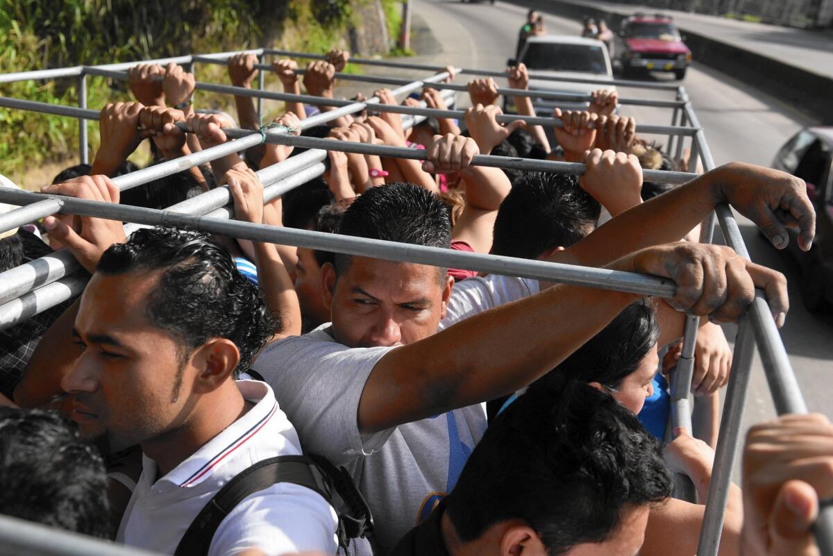 With few buses running, residents of San Salvador scramble for any kind of transportation they can find in a city with no subway or suburban train system.