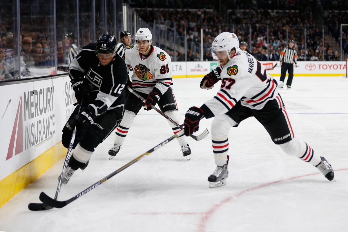 Kings forward Marian Gaborik chases a loose puck against Blackhawks Trevor van Riemsdyk (57)and Patrick Kane (88) during a game on Nov. 28.