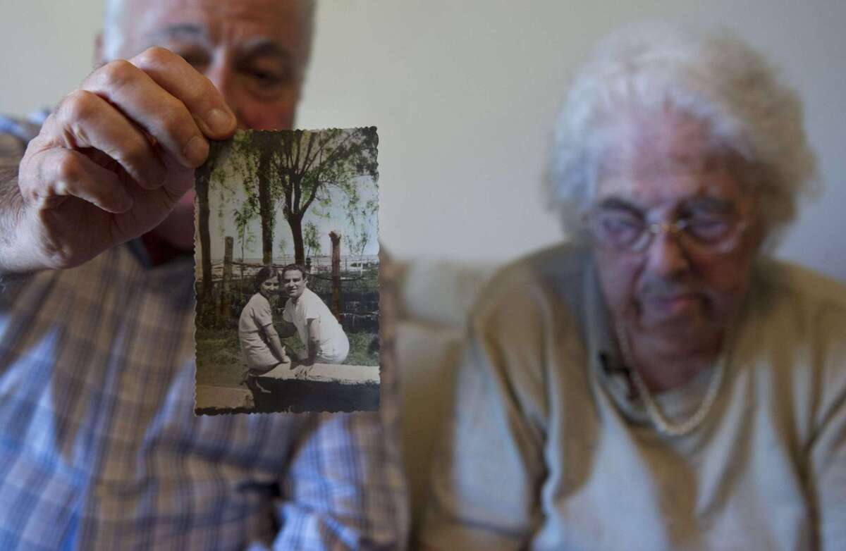 Armenian Lucin Khatcherian (right), 106, the sole survivor of the Armenian Genocide living in Argentina, and her son Eduardo, 74, recently looked at old family pictures and documents.