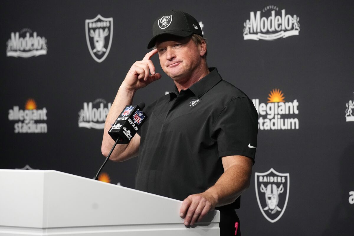 FILE - Las Vegas Raiders head coach Jon Gruden attends a news conference after an NFL football game against the Miami Dolphins in Las Vegas, in this Sunday, Sept. 26, 2021, file photo. Jon Gruden is out as coach of the Las Vegas Raiders after emails he sent before being hired in 2018 contained racist, homophobic and misogynistic comments. Gruden released a statement Monday night, Oct. 11, 2021, that he is stepping down after The New York Times reported that Gruden frequently used misogynistic and homophobic language directed at Commissioner Roger Goodell and others in the NFL.(AP Photo/Rick Scuteri, File)