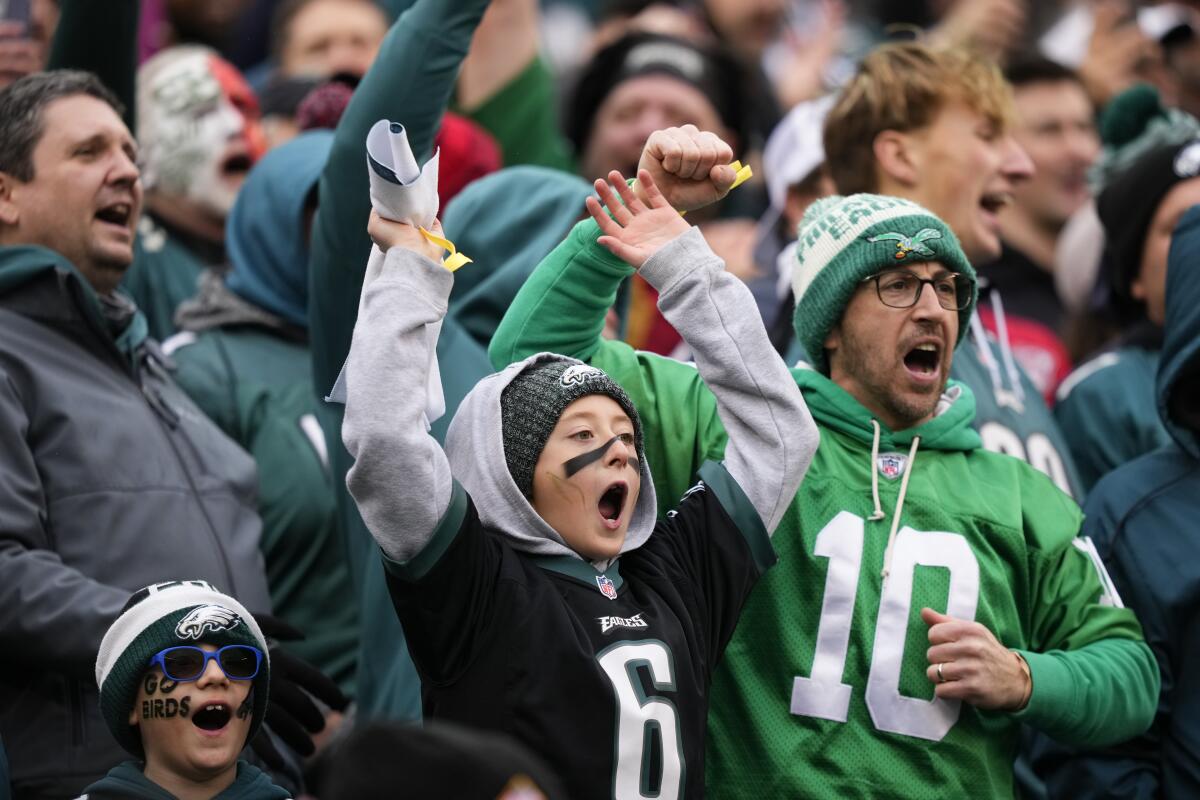 Philadelphia sports fans celebrating after victorious weekend