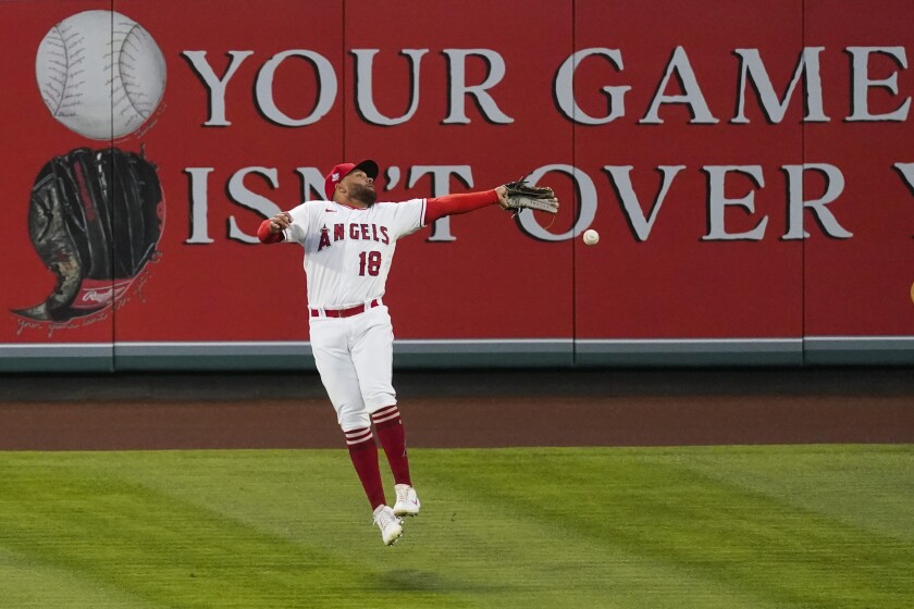 Angels right fielder Jose Rojas fails to catch a fly ball hit by Oakland's Mark Canha during the third inning Saturday.
