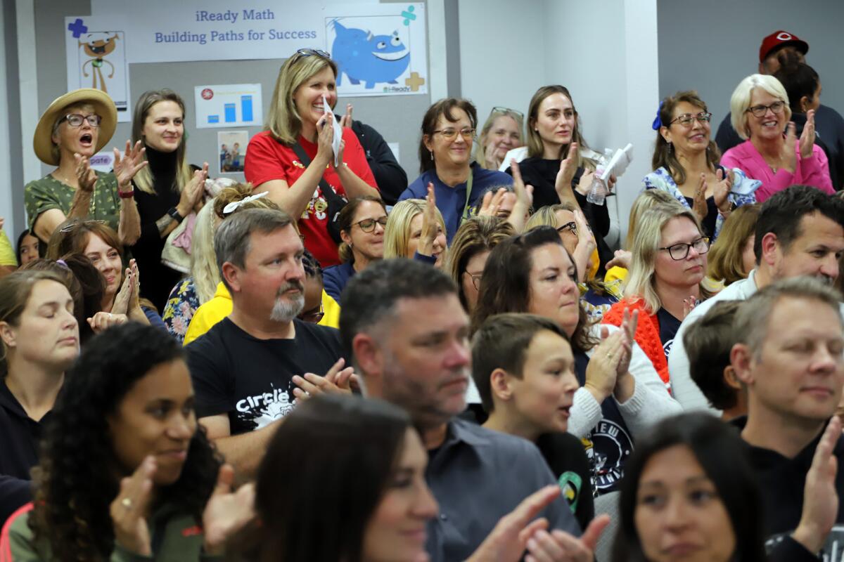 Parents and students applaud at the Ocean View School District board meeting.