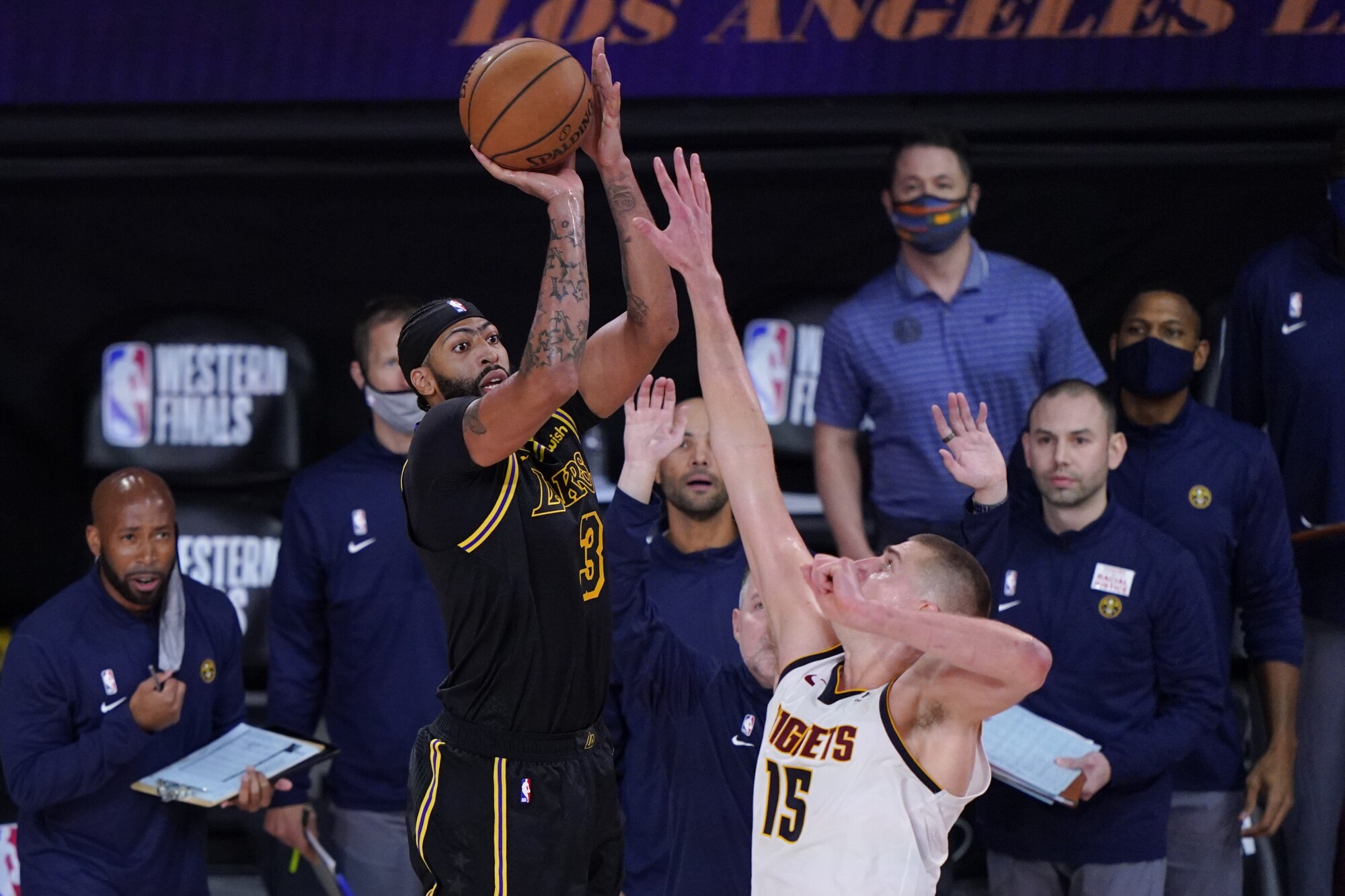 Lakers forward Anthony Davis shoots a three-pointer over Denver Nuggets center Nikola Jokic.