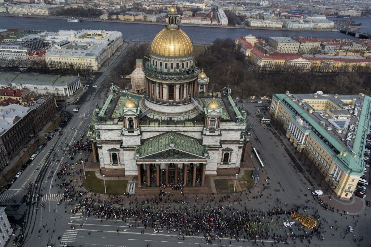 FILE - In this file aerial photo taken on Sunday, April 13, 2014 , Orthodox priests and believers participate in the Palm Sunday procession around the St. Isaak's Cathedral in St. Petersburg, Russia. The Russian Orthodox Church on Friday, July 31, 2015 defended its controversial bid to fully take over St. Petersburg's landmark St. Isaac's Cathedral, saying it's in line with the law and wouldn't hamper tourist access. (AP Photo/Dmitry Lovetsky, file)