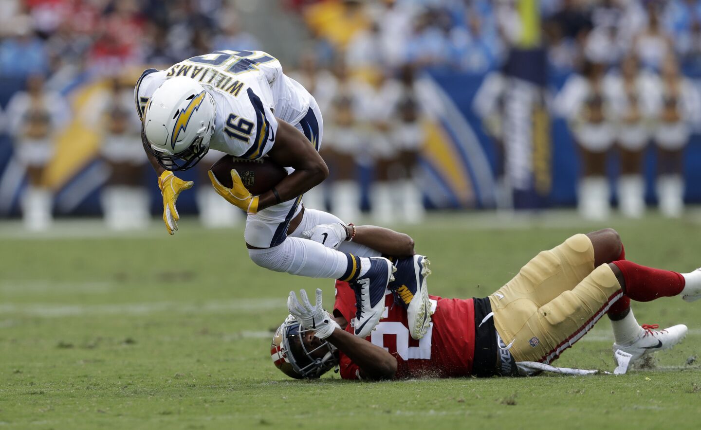 Los Angeles Chargers wide receiver Tyrell Williams, left, is tackled by San Francisco 49ers cornerback Ahkello Witherspoon during the first half of an NFL football game, Sunday, Sept. 30, 2018, in Carson, Calif.