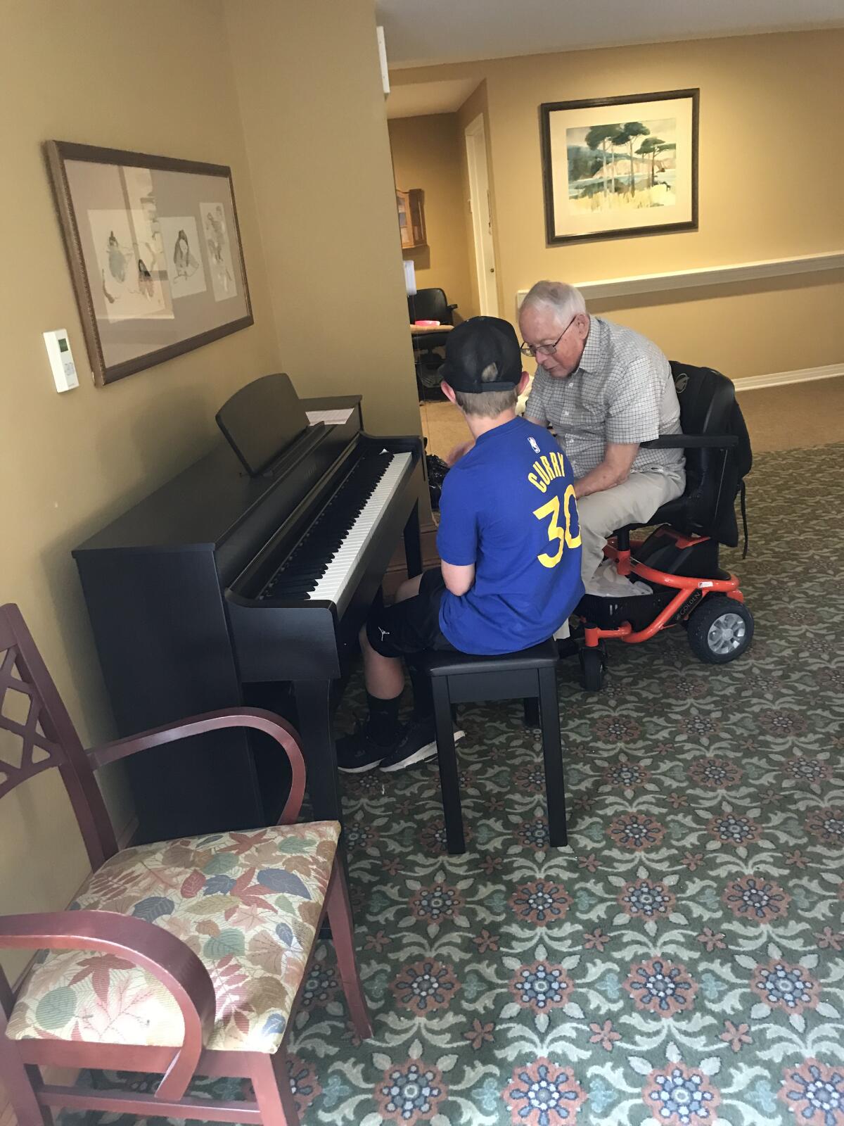 White Sands resident Jim Jackson teaches piano to one of the children participating in a week's worth of activities.