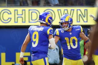 Rams quarterback Matthew Stafford (9) congratulates Cooper Kupp for his touchdown catch.