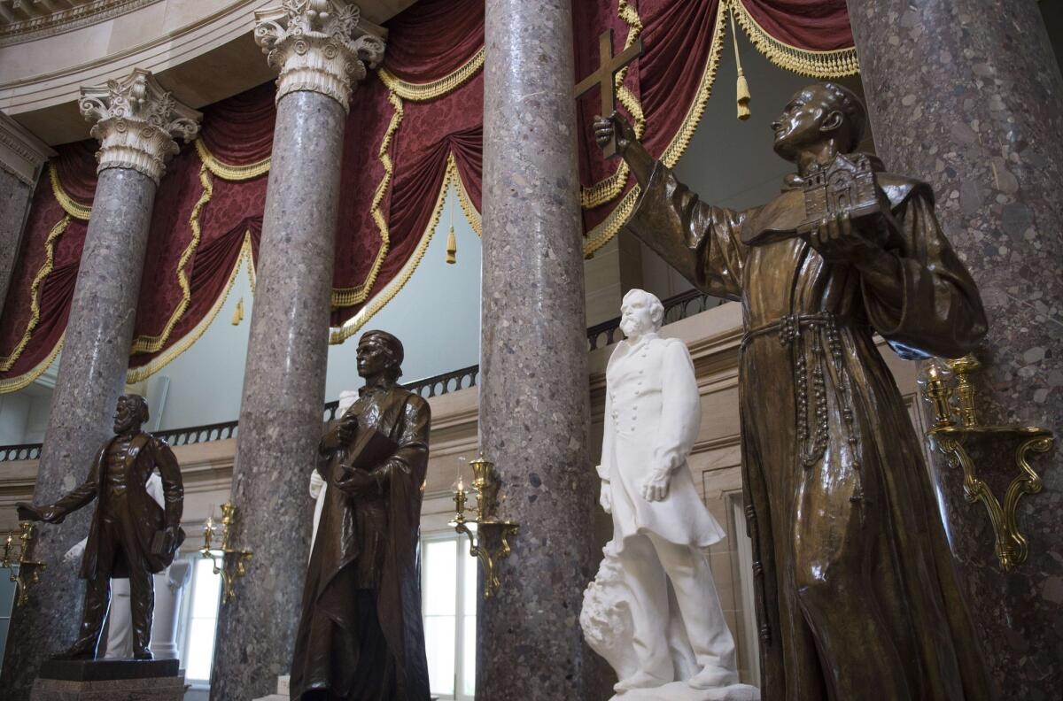 A statue of Father Junipero Serra, right, would be replaced in the U.S. Capitol's Statuary Hall by one of Sally Ride under a proposal by a California state senator.