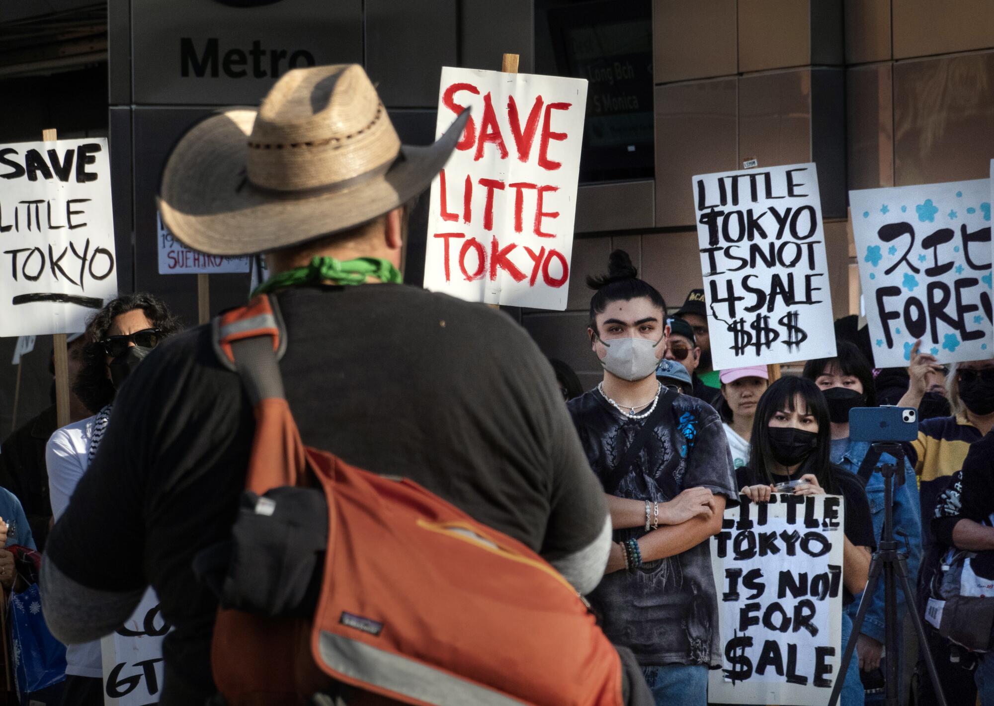 A rally with signs seeking to save Little Tokyo protest the eviction of Suehiro Café.