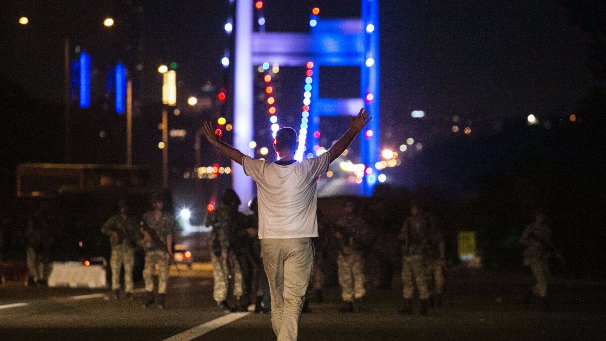 A man approaches Turkish soldiers on the Bosphorus Bridge in Istanbul on July 16, 2016.