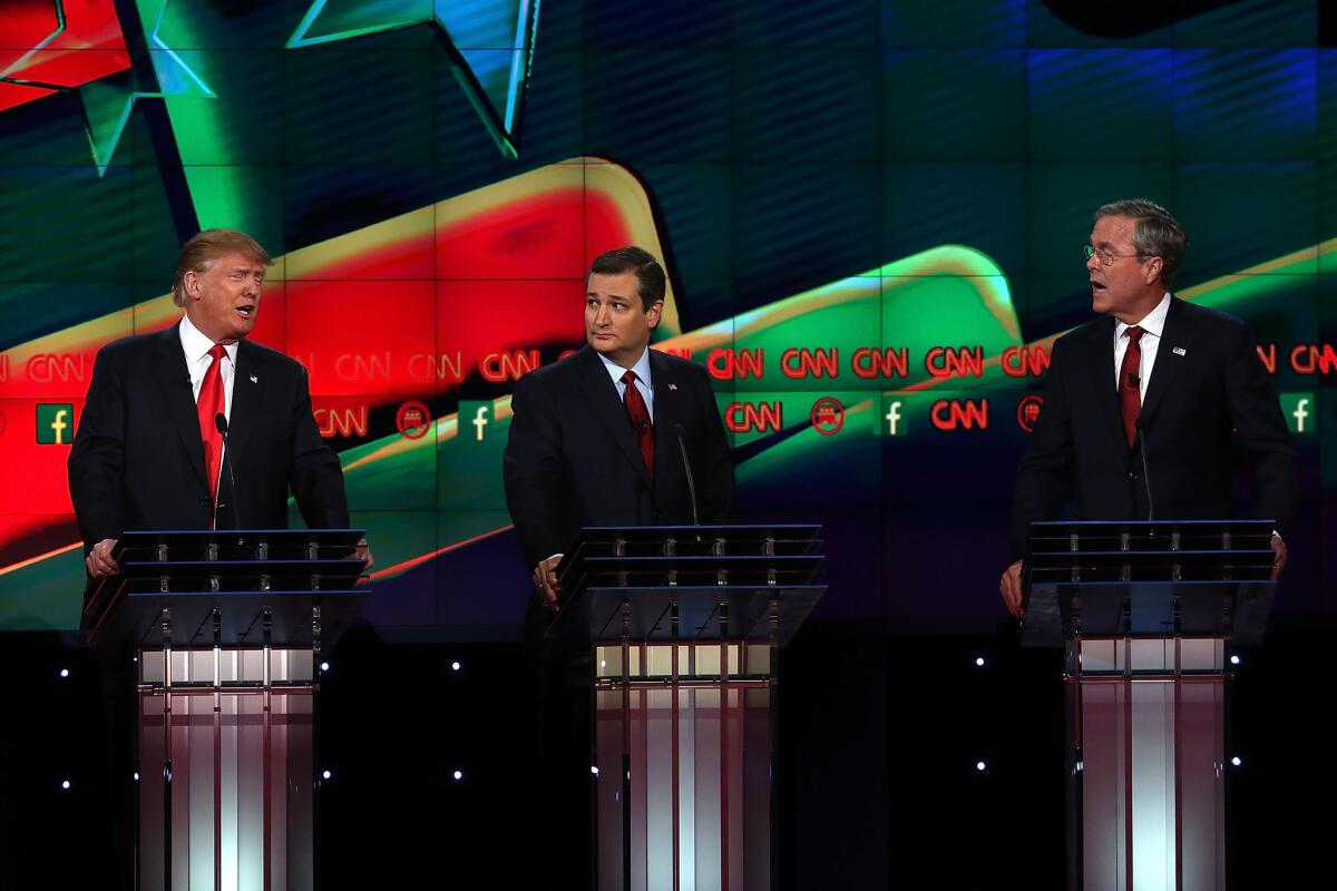 Republican presidential candidates Donald Trump, left, and Jeb Bush get personal during the CNN Republican presidential debate on Tuesday in Las Vegas.