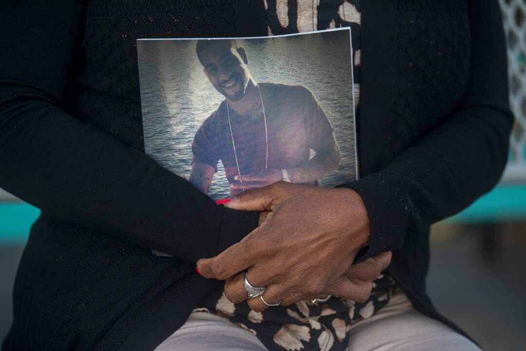 Two hands clasp a book of photos