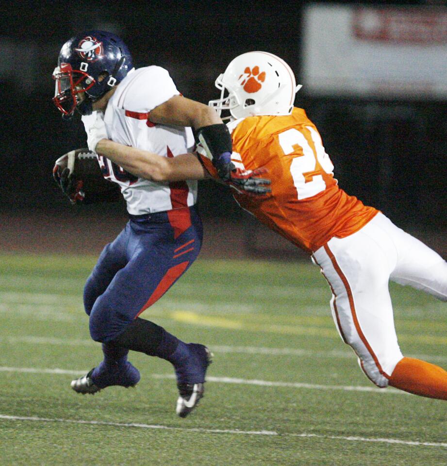 Bell-Jeff's Josh Martinez, left, is tackled by Pasadena Poly's Josh Martinez during a game at South Pasadena High School on Friday, September 28, 2012.