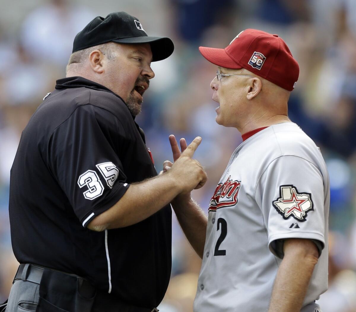 Veteran umpire Wally Bell, shown arguing last season with Brad Mills, then the Houston Astros' manager, has died of an apparent heart attack at age 48.
