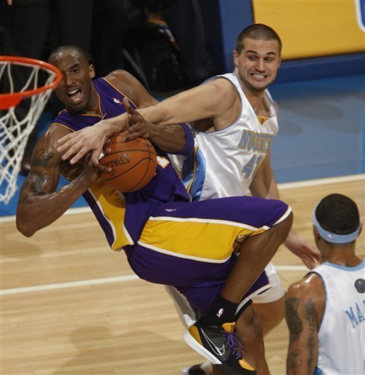 Kobe Bryant of the Western Conference passes against Kenyon Martin
