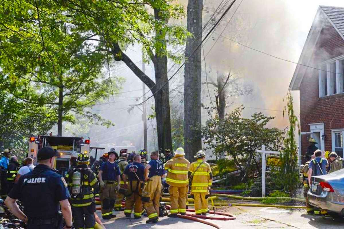 Personal de emergencias, bomberos y policías acuden al lugar donde una casa explotó y se incendió en la calle Garland en Edgewood, Pensilvania.