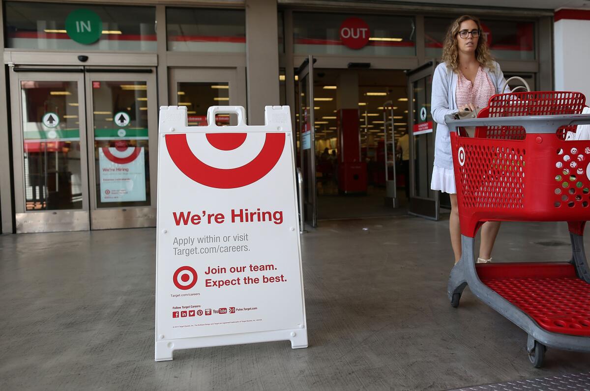 A "Wer're Hiring" sign is seen outside a Target store in Miami on Sept. 4.