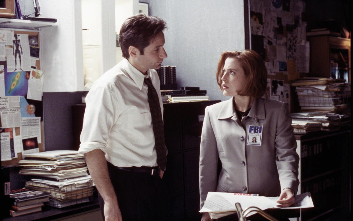 "The X-Files" stars David Duchovny and Gillian Anderson look successful cluttered basement FBI office.