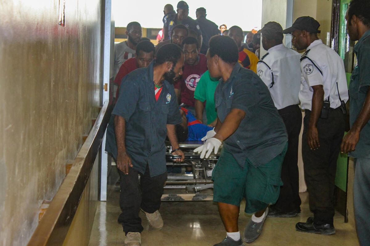 An injured student is rushed to the emergency room at Port Moresby General Hospital on June 8, 2016 in Port Moresby, Papua New Guinea.