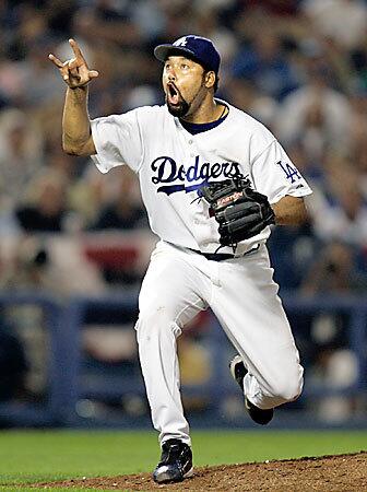 Dodgers pitcher Jose Lima reacts after striking out St. Louis Cardinals center fielder Jim Edmonds in the 7th inning in Game 3 of the National League playoffs at Dodger Stadium on Oct. 9, 2004. Lima died Sunday of an apparent heart attack. He was 37.