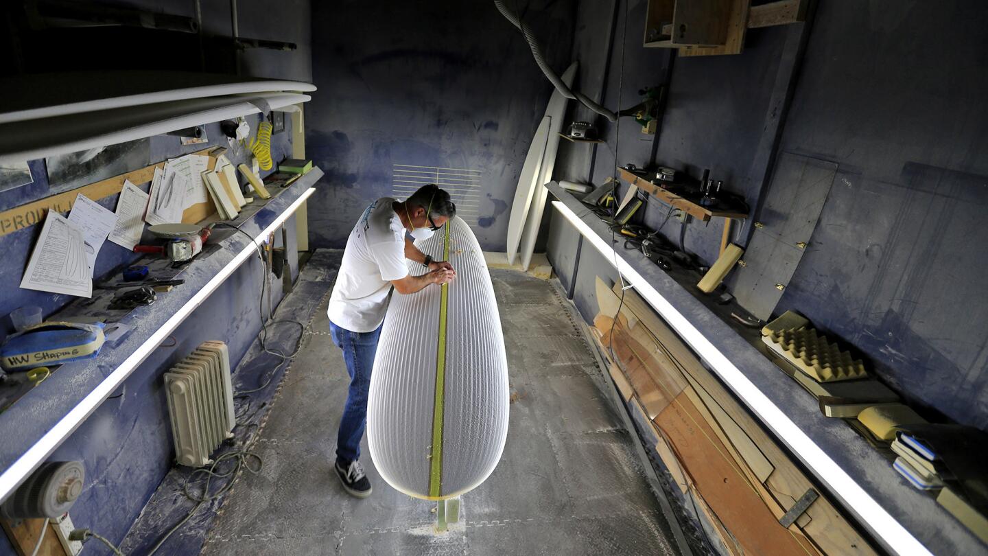 Mark Johnson, head of sales and development for Hobie Designs in San Juan Capistrano, shapes a surfboard from a piece of polyurethane foam. “You never know how the board is going to turn out until it’s done,” he says.